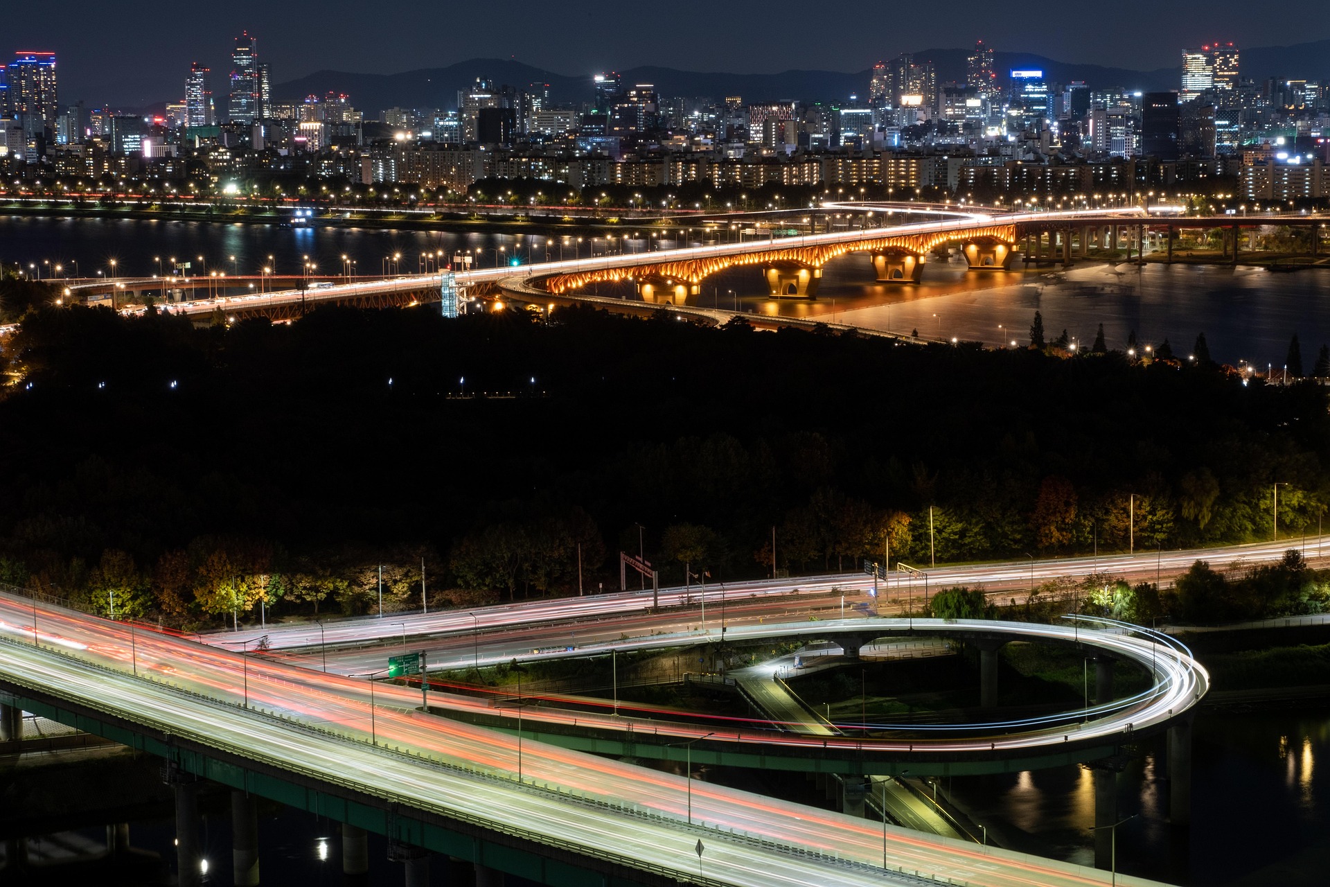 City highway and bridge at night with light trails
